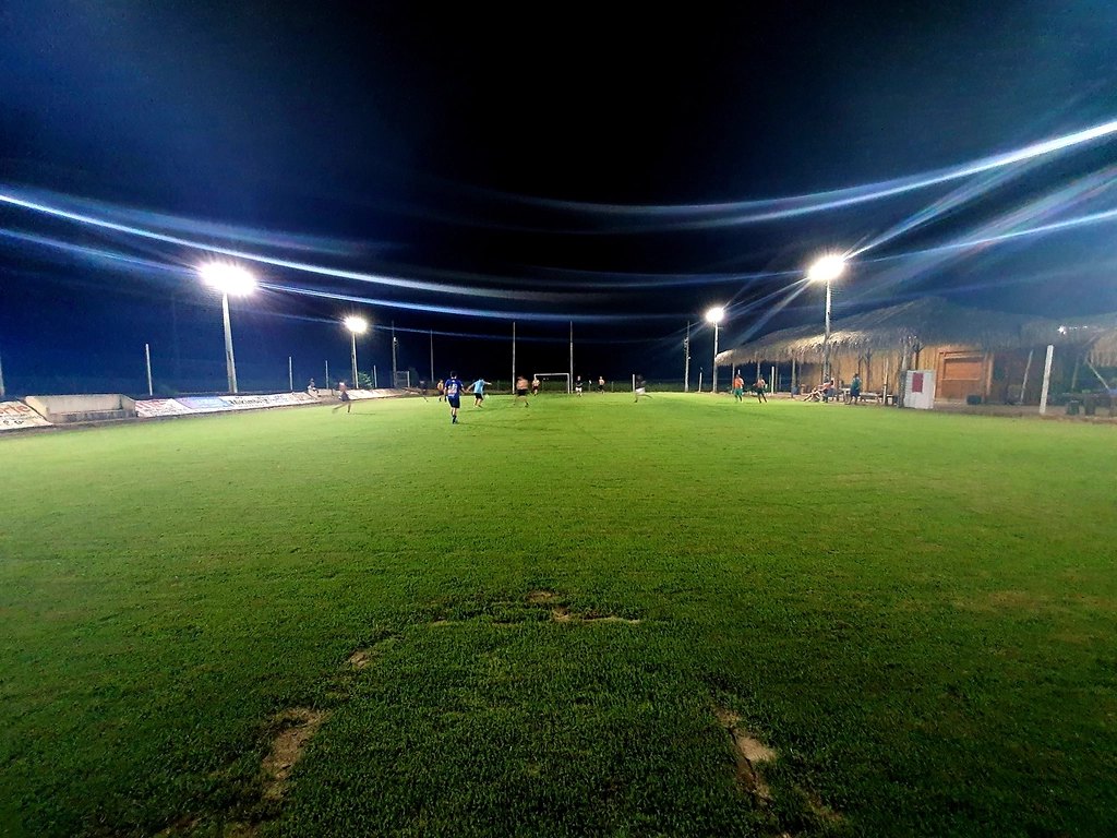 A football pitch under floodlights at night
