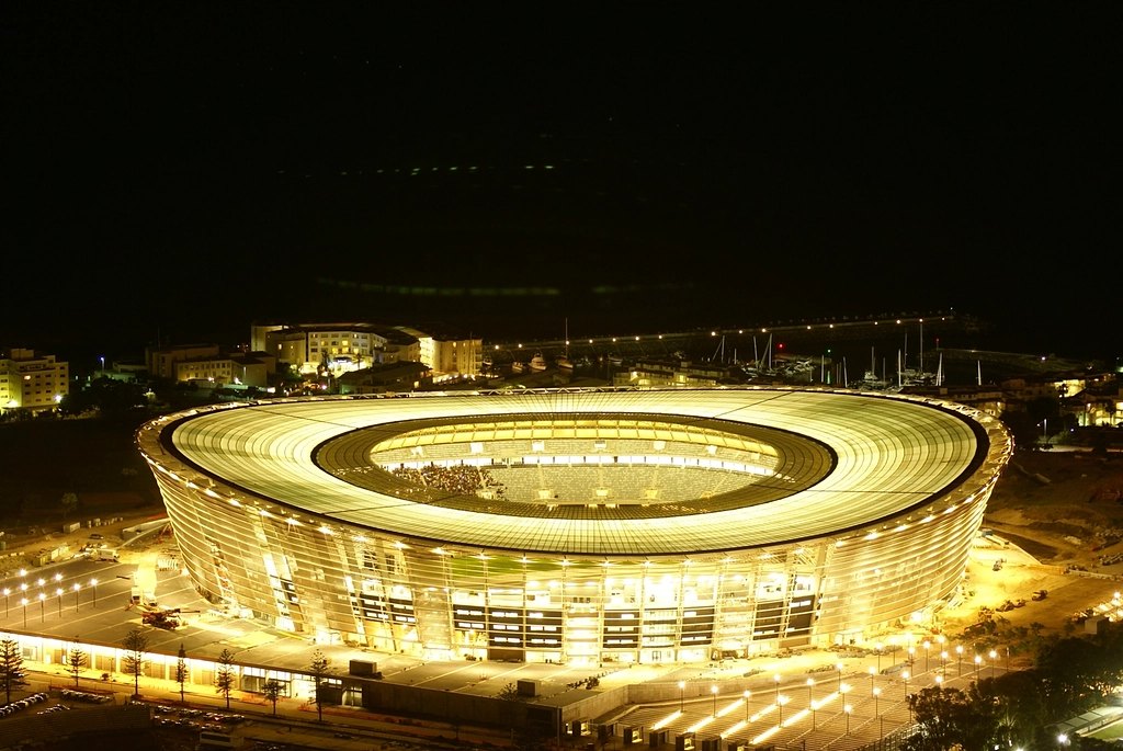 A football stadium glowing gold at night